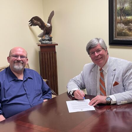 l-r Dr. Todd Brenneman and President Mitch Henry sign an agreement with West Virginia School of Preaching.