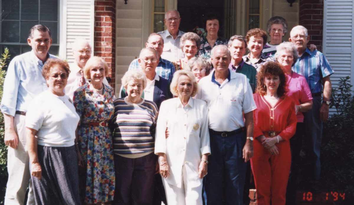 Jesse and Patricia Russell stand among their friends and peers for the Ann Street Alumni Reunion at alumni Bill and Bettye Beck's home in October 1994.
