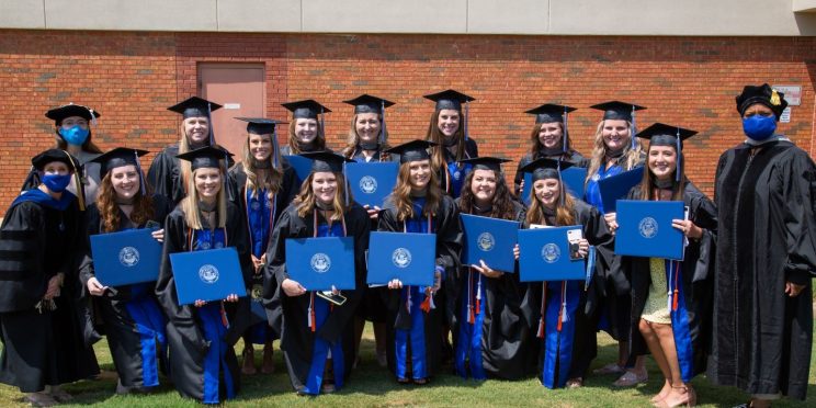 Speech-Language Pathology graduates and professors pose after the commencement ceremony. Back row l-r: Dr. Leah Fullman, Elizabeth Meadows, Ragan Knotts, Mollie Carter, Brittany Cooper, Kelli Mallett, Kandice Cleckler, Kelsie Ulrich. Front row l-r: Dr. Amy Ogburn, Caitlyn Barnes, Emily Hadley, Tabitha Hendrick, Kristin Williams, Kaitlyn Hale, Lindsey Mullino, Hailey Loria, Dr. Cara Tyson.