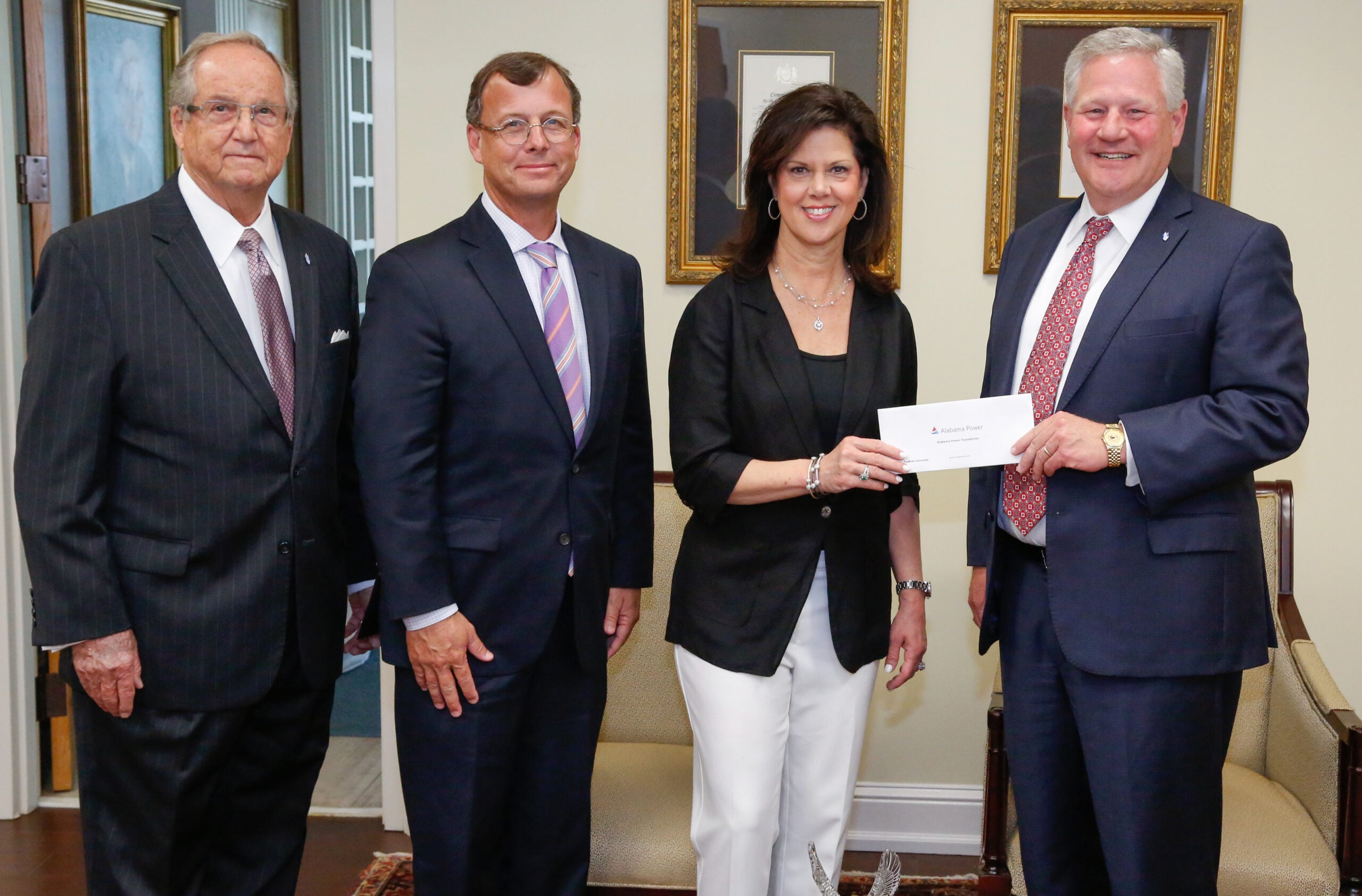 Alabama Power executives Mike Jordan and Leslie Sanders presents a grant for the College of Health Sciences to President Mike Williams and Vice Chancellor Wayne Baker.