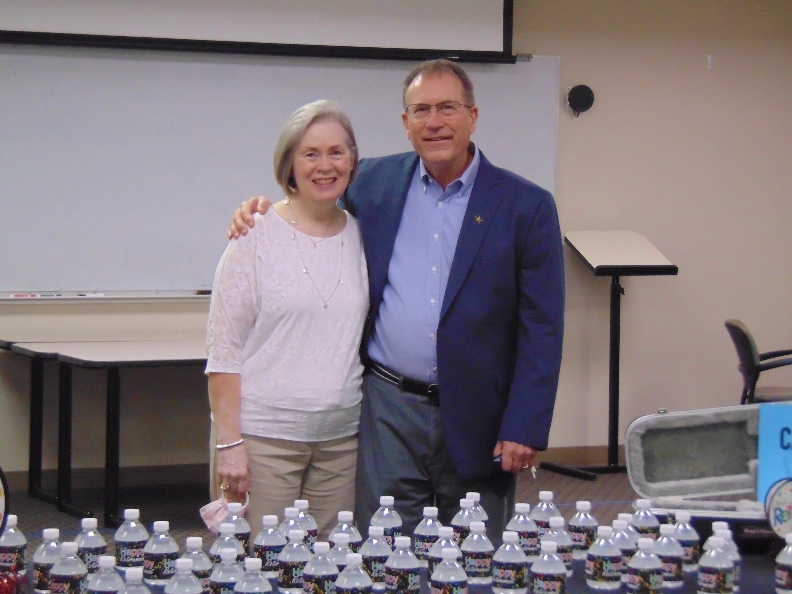 Alan Kaye stands with his wife Shirley during his retirement ceremony from the MSM program.