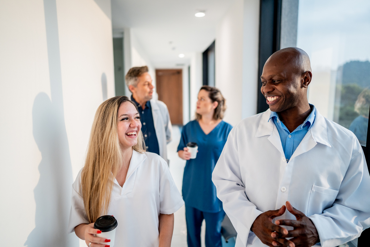 Doctor and nurse talking while walking in the hospital