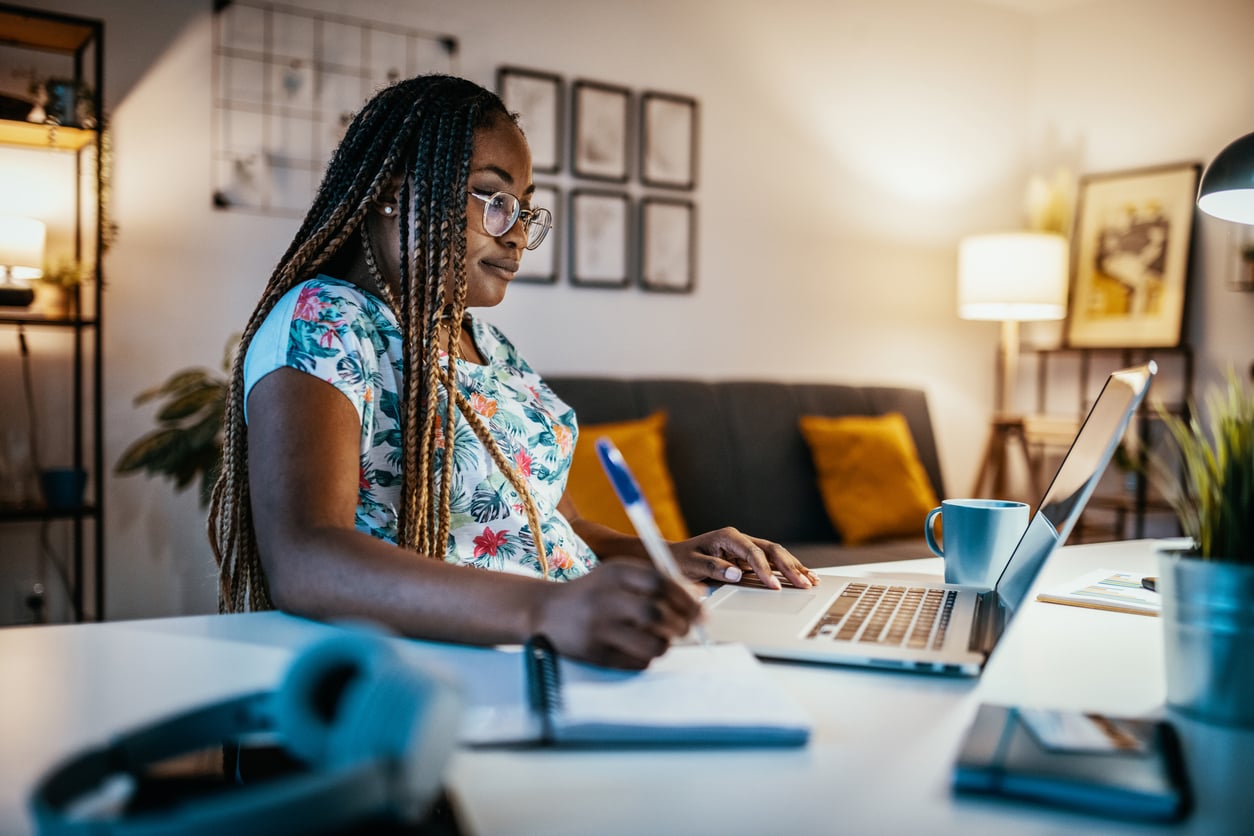 Online degree student studies with laptop at home