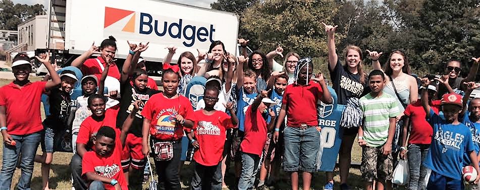 Davis Elementary Students taking a picture at a Faulkner football game