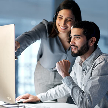 Teacher and student looking at computer