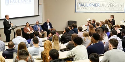 Man speaking to business students