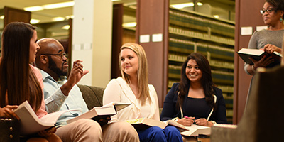 Faulkner Law students talking in the library