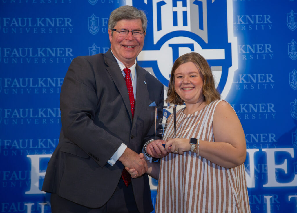 Auburn Chason is awarded the Accomplished Alumna Award from President Mitch Henry. 