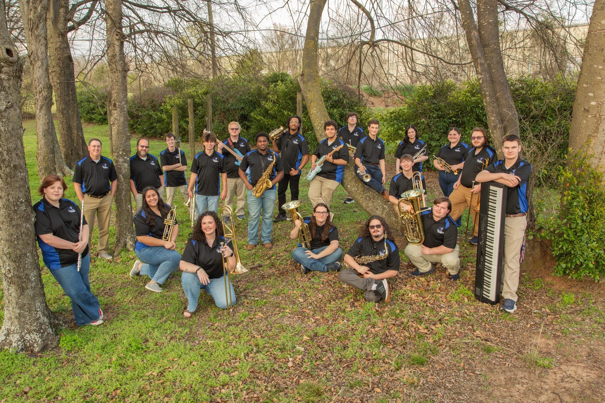 The Faulkner Swingin' Eagles jazz band smiling outdoors with their instruments