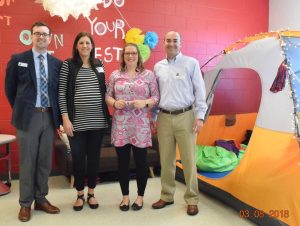 Faulkner University's College of Education’s Distinguished Alumna, Britney Fureigh, stands in her classroom with (l-r) Pike Road Elementary School Principal Ryan Kendall, Faulkner’s College of Education Dean Leslie Cowell, Ph.D. and alumni officer, Adam Donaldson.
