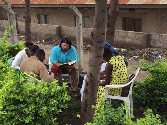 Justin Maynard teaches a Bible class to a group in Tanzania, Africa.