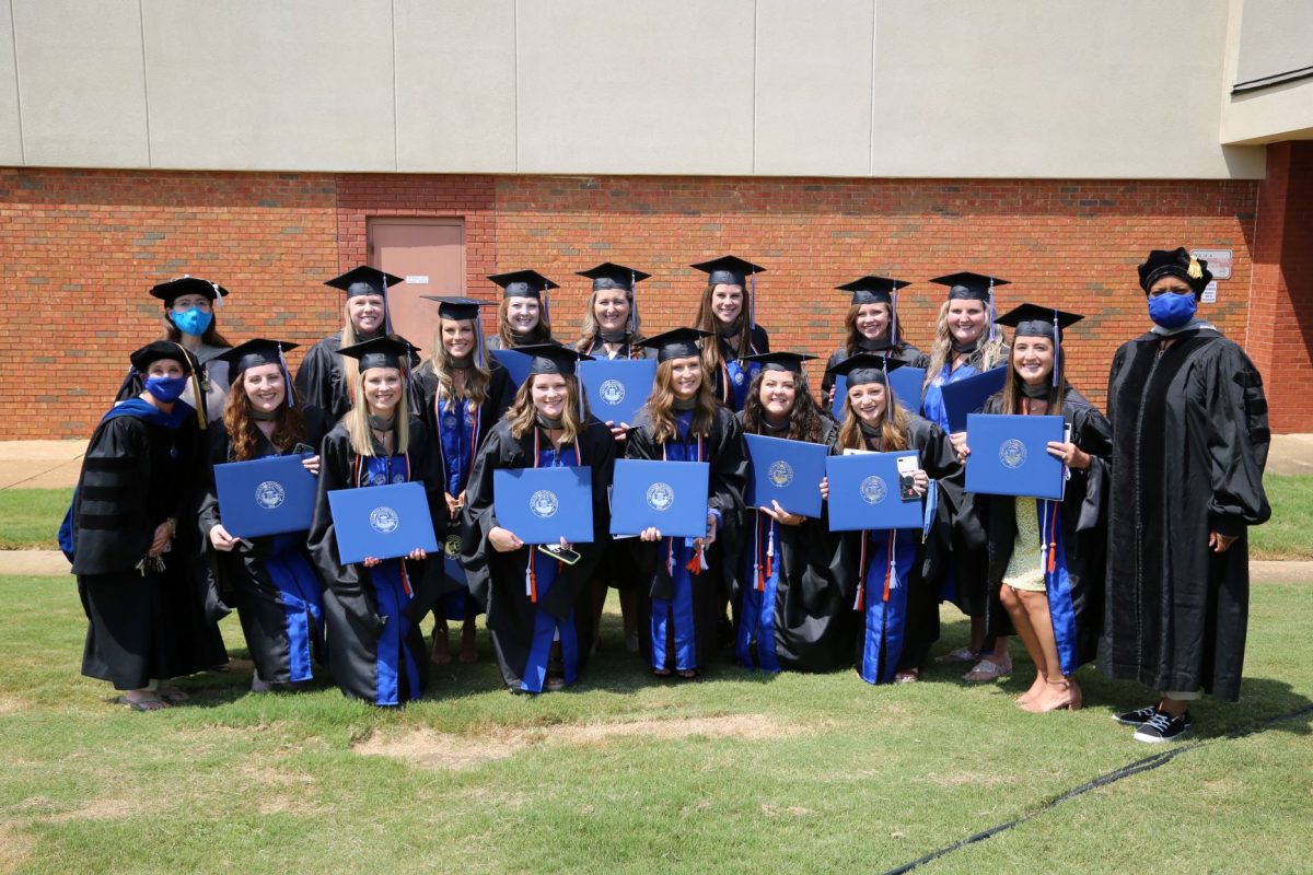 SLP graduates pose for a group picture following the 2020 Spring commencement ceremony. 