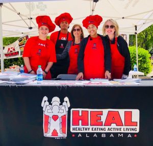 Marie Ottinger, center and Lisa Williams, right, invite several student HEAL representatives from Faulkner to Birmingham’s National Walk at Lunch Day on April 11, 2018.