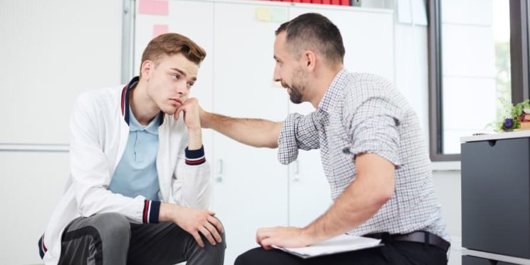 A sports psychologist talks with a young athlete
