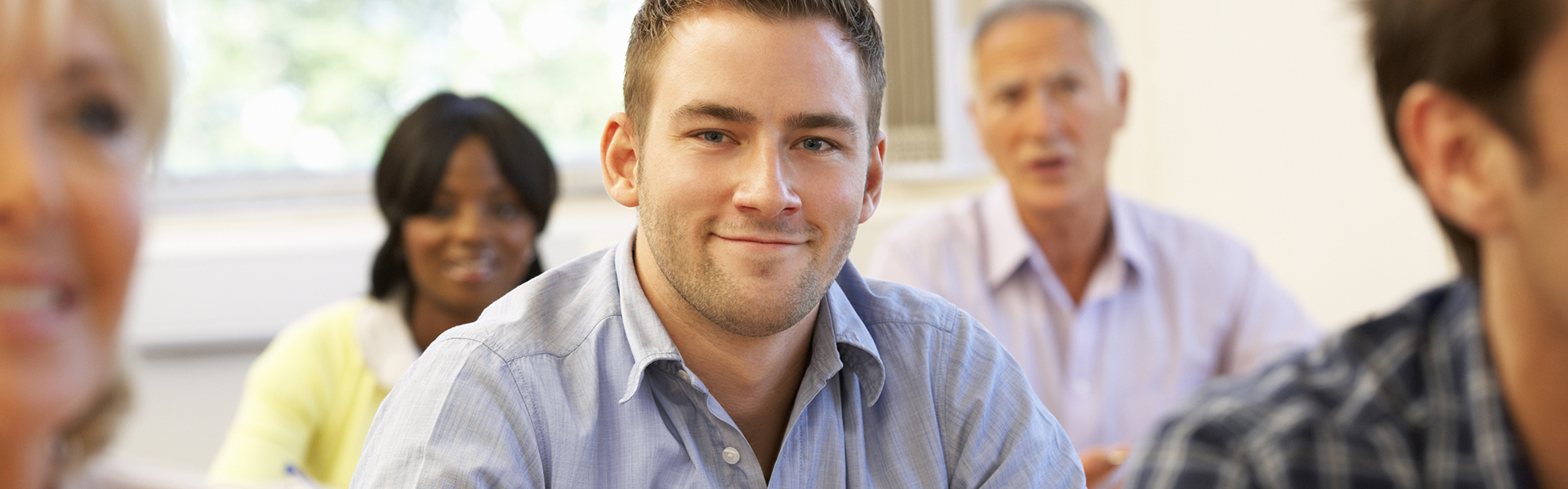 ADULTCLASS1 Adult student smiling in class with other students