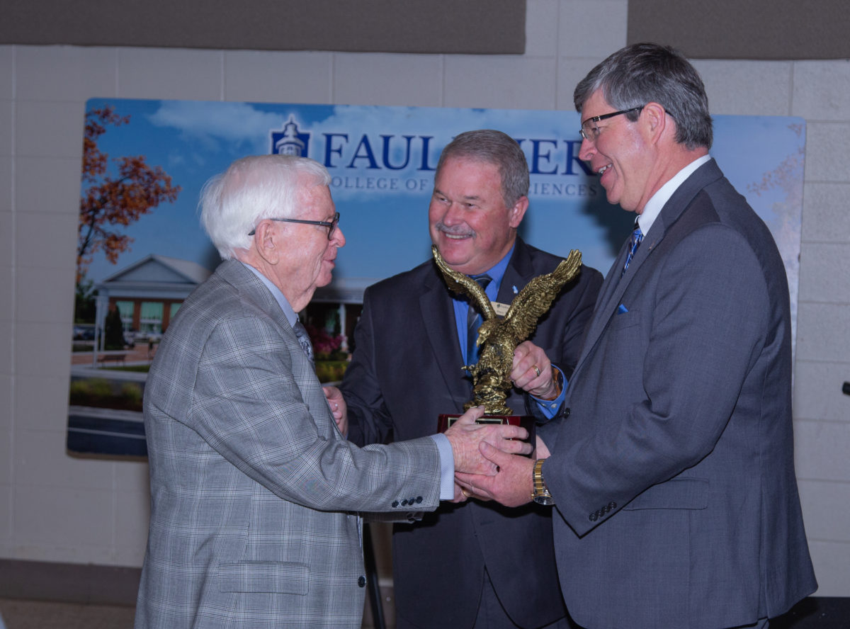 L-r, E.R. Brannan, is presented the Alumnus of the Year Award by Joey Wiginton and President Mitch Henry. 