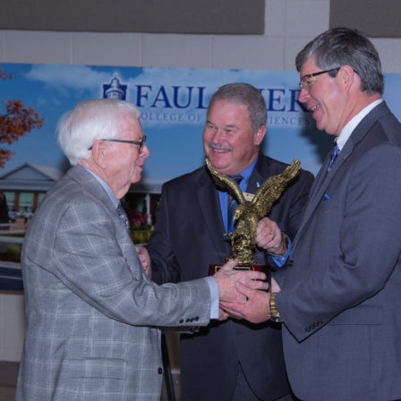 L-r, E.R. Brannan, is presented the Alumnus of the Year Award by Joey Wiginton and President Mitch Henry.
