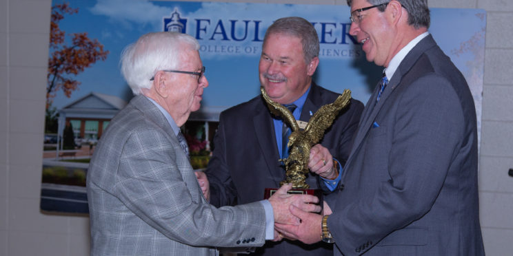 L-r, E.R. Brannan, is presented the Alumnus of the Year Award by Joey Wiginton and President Mitch Henry.