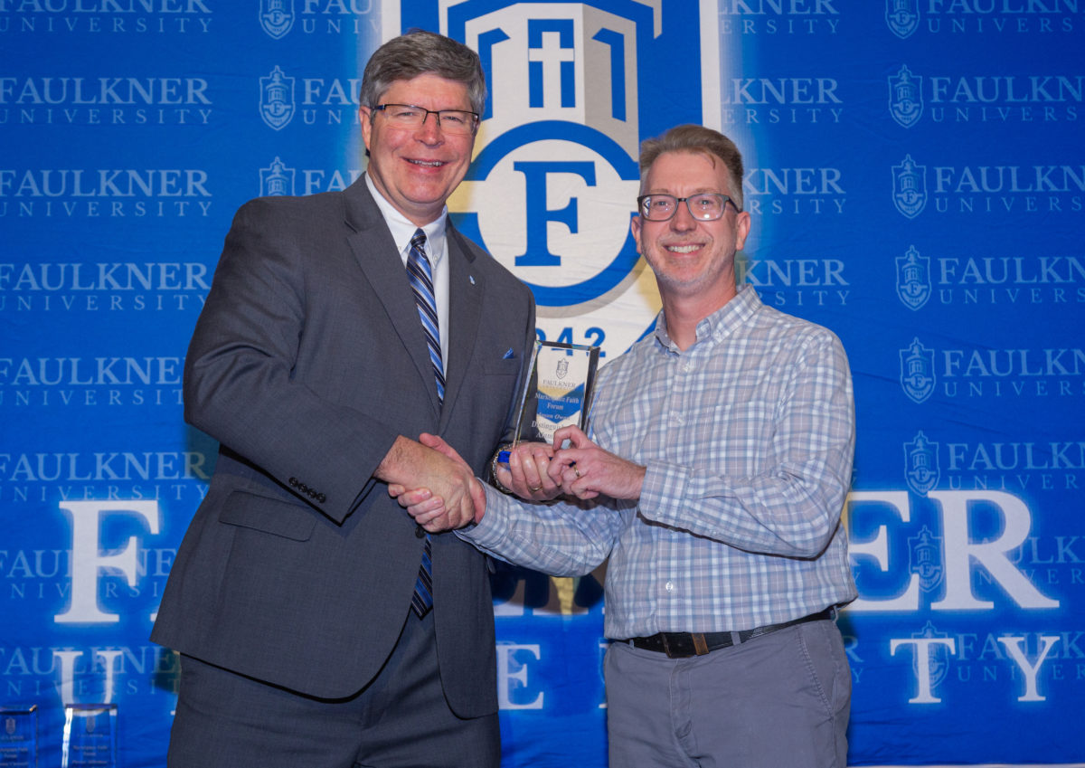 President Mitch Henry, left, awards Jason Owen the Distinguished Alumnus Award. 