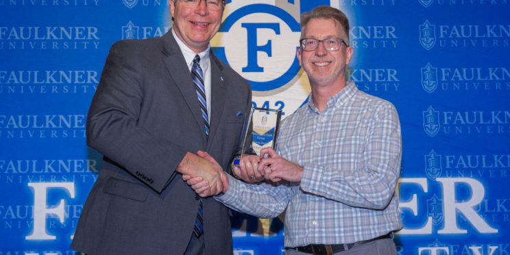 President Mitch Henry, left, awards Jason Owen the Distinguished Alumnus Award.
