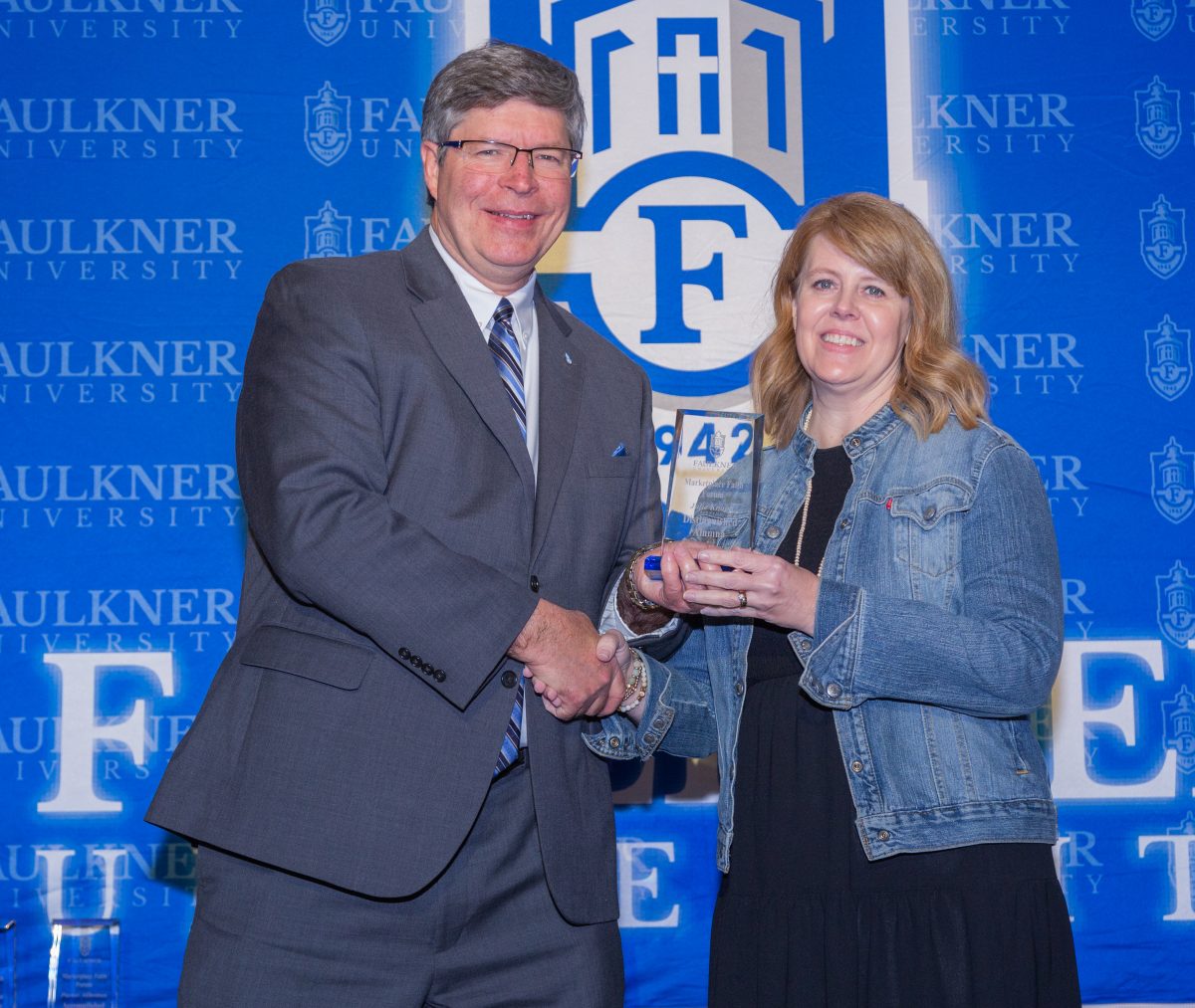 Faulkner President Mitch Henry presents the Distinguished Alumna Award to Julie Knapp.