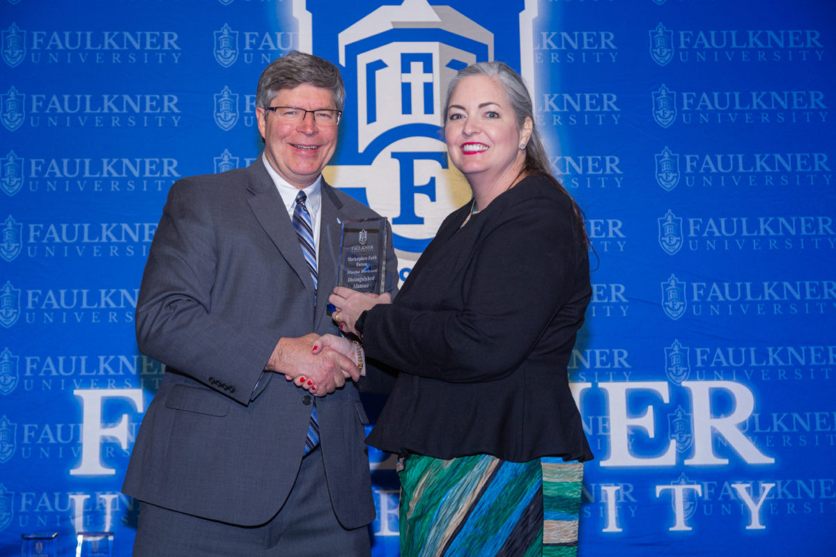 l-r President Mitch Henry presents Martha Burleson with her Distinguished Alumna Award for the 2023 Marketplace Faith Friday Forums. 