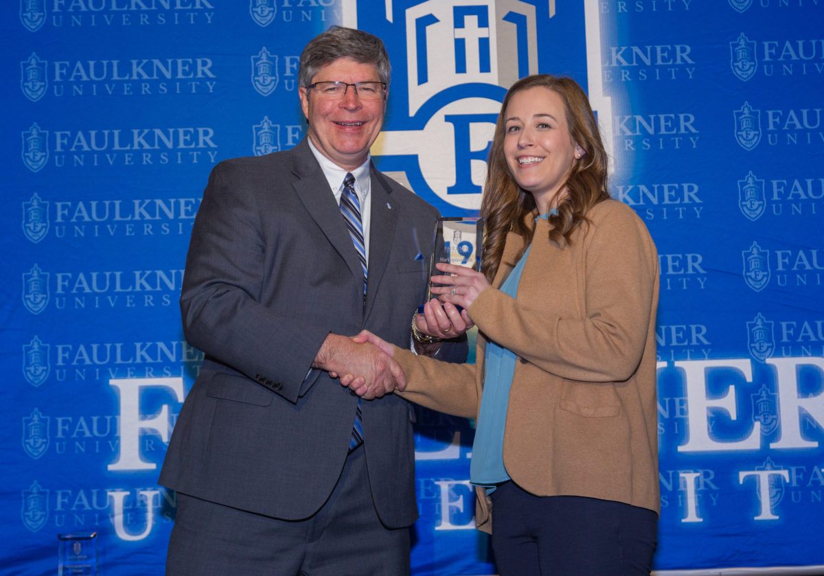 President Mitch Henry presents an Alumni Award to Olivia Boro during the 2023 Marketplace Faith Friday Forums.