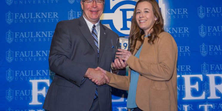 President Mitch Henry presents an Alumni Award to Olivia Boro during the 2023 Marketplace Faith Friday Forums.