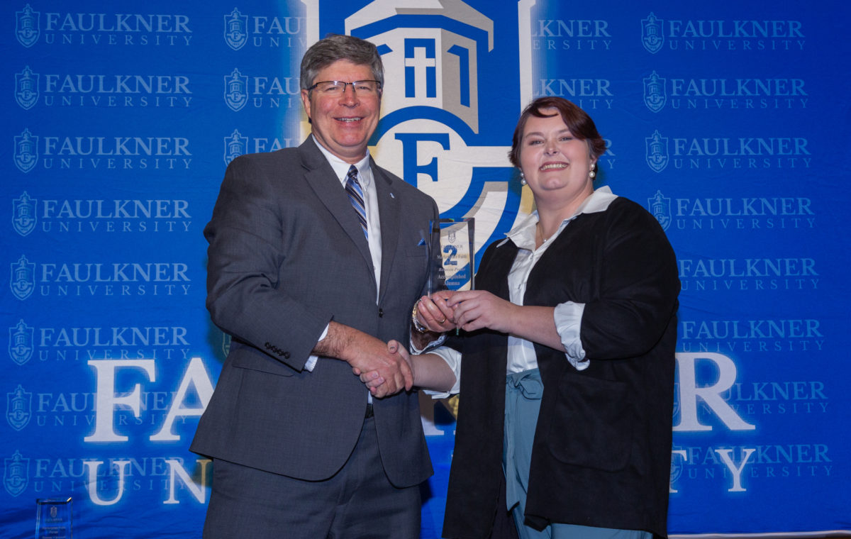 President Mitch Henry awards Rebecca Potter at this year's Faith Forums.