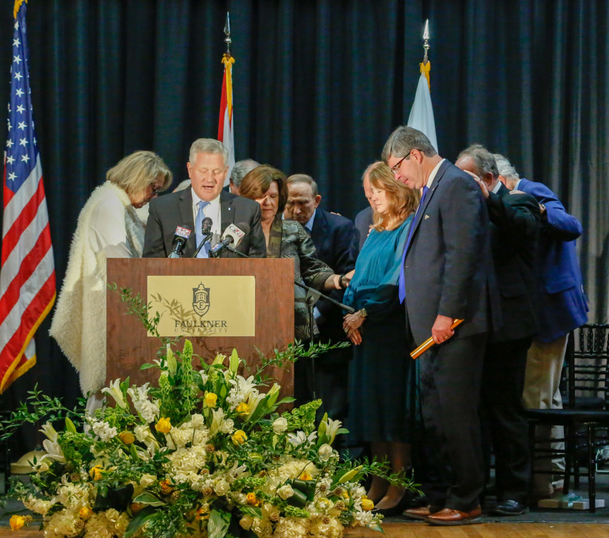 Faulkner University Board of Trustee members, Mike Williams, his wife Lisa Williams lay hands on President-elect Mitch Henry and his wife Cindy in prayer following the announcement of Henry's selection as Faulkner's next president. 