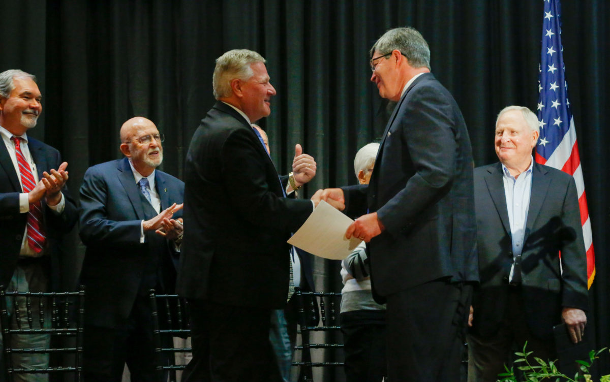 Faulkner University's President Mike Williams congratulates President elect Mitch Henry.