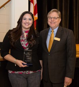 Sheena Ariel Riley Gore stands with David Johnson after being awarded the College of Business Young Alumna of the Year Award.