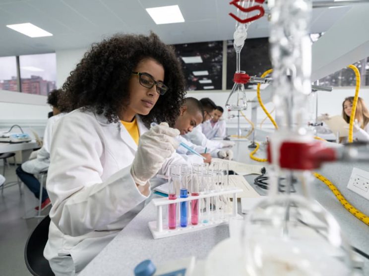 Student works in lab with classmates