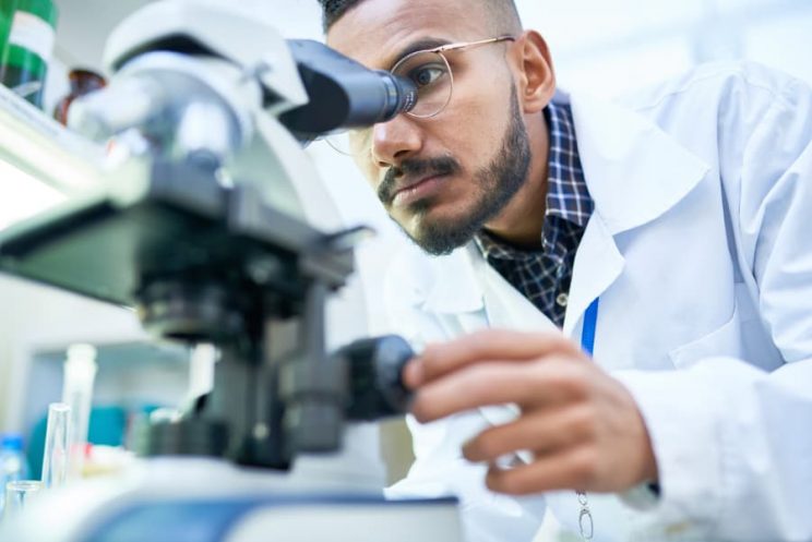 Biochemistry student uses microscope