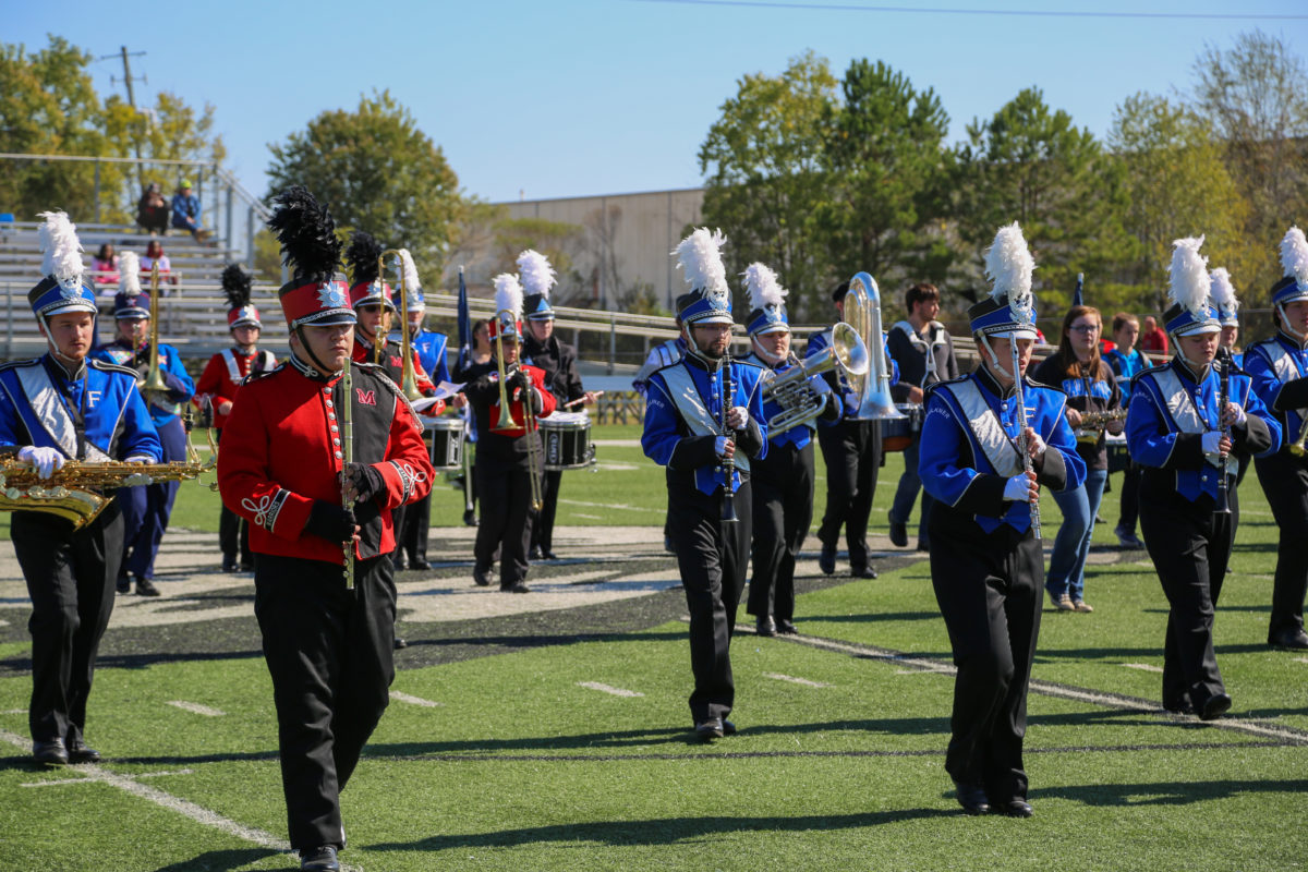 High school marching band students pose with Faulkner's Marching Eagles.