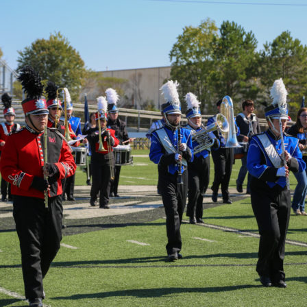 High school marching band students pose with Faulkner's Marching Eagles.