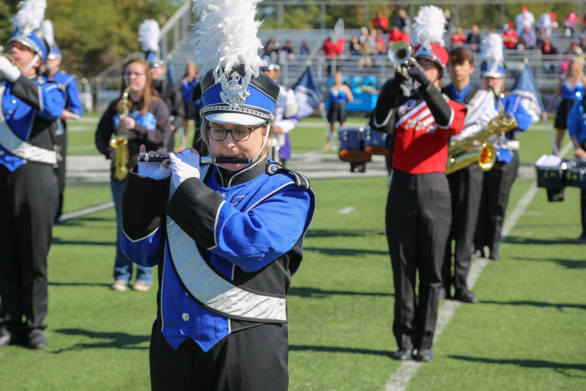 High school marching band students pose with Faulkner's Marching Eagles.