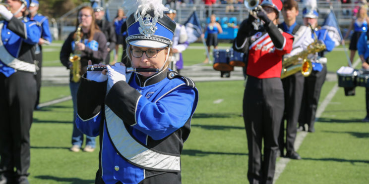 High school marching band students pose with Faulkner's Marching Eagles.