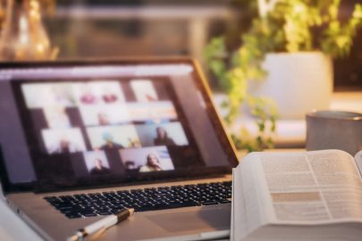 Bible Open In Front Of Laptop