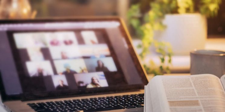 Bible Open In Front Of Laptop