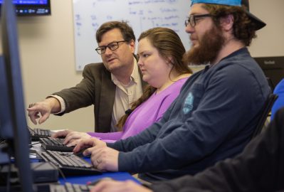 Mike Herridge, left, helps Computer Science students.