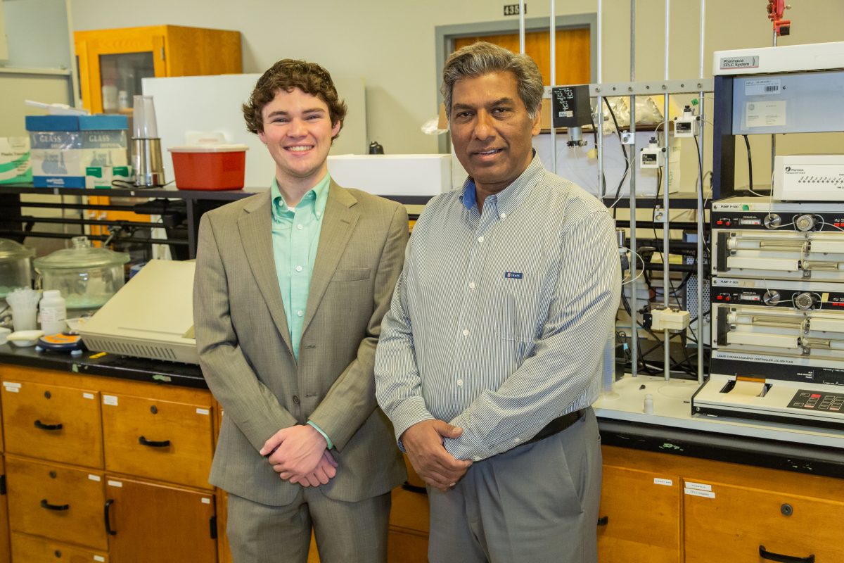 l-r Peyton Osborn and Dr. Theodore Sabir stand inside Faulkner's chemistry lab.