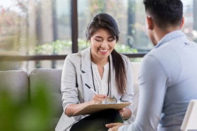 Clinical psychologist taking notes during patient appointment