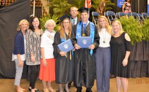 Tammy Wilson and Hunter Wilson, center, stood with family and friends following thier graduation from Faulkner University. 