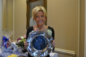 Dr. Dixie Hicks holds a platter given to her as a gift as her retirement reception at Faulkner University. 