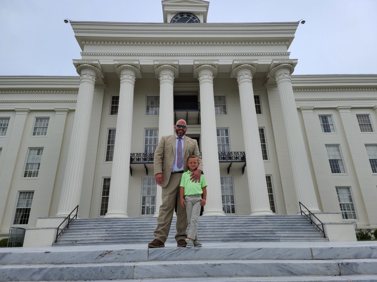  DA Jeremy Duerr stands on the steps of the Capitol, with his son Stephen.
