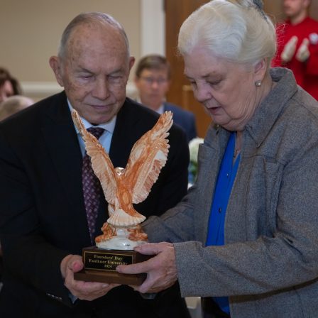 Beau Greer and Joy Greer accept a special Alabama Clay Eagle in honor of their family on Founders Day.