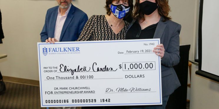 Elizabeth Carden, right, holds a check for $1,000. Next to her are Donna Churchwell and David Gregor.