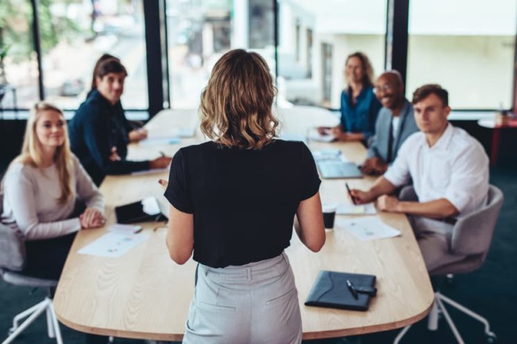 Business administration graduate conducting an employee orientation