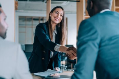 Human resources manager shaking hands with a newly hired employee